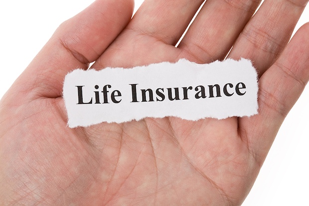 A piece of paper in a hand that says "life insurance" 